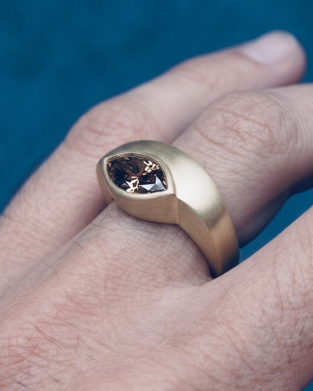 envelope ring worn on the hand, side view